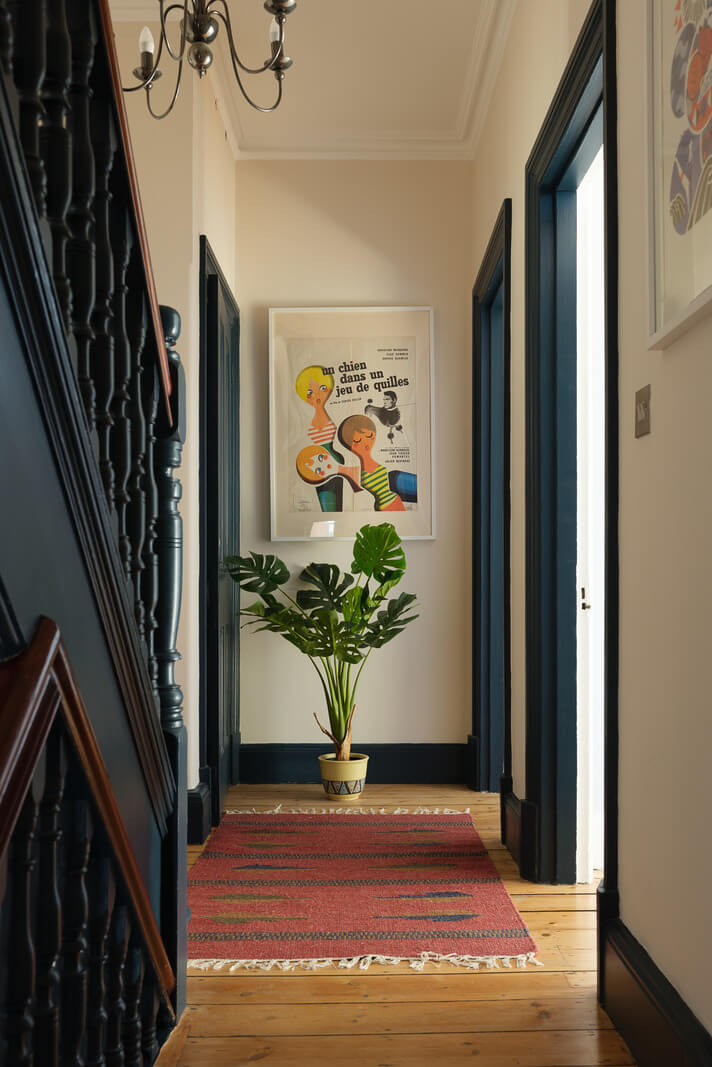 Playful Colors in a Historic Home in Kent 10 hallway-wooden-floor-pink-rug-nordroom