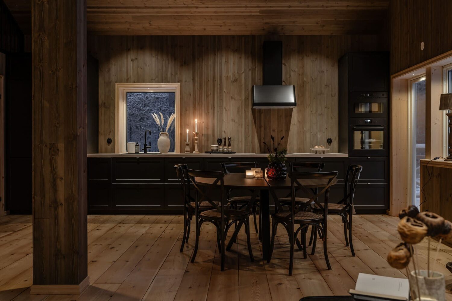 A Cozy Log House in Sweden 4 kitchen-dining-space-at-night-log-house-sweden-nordroom