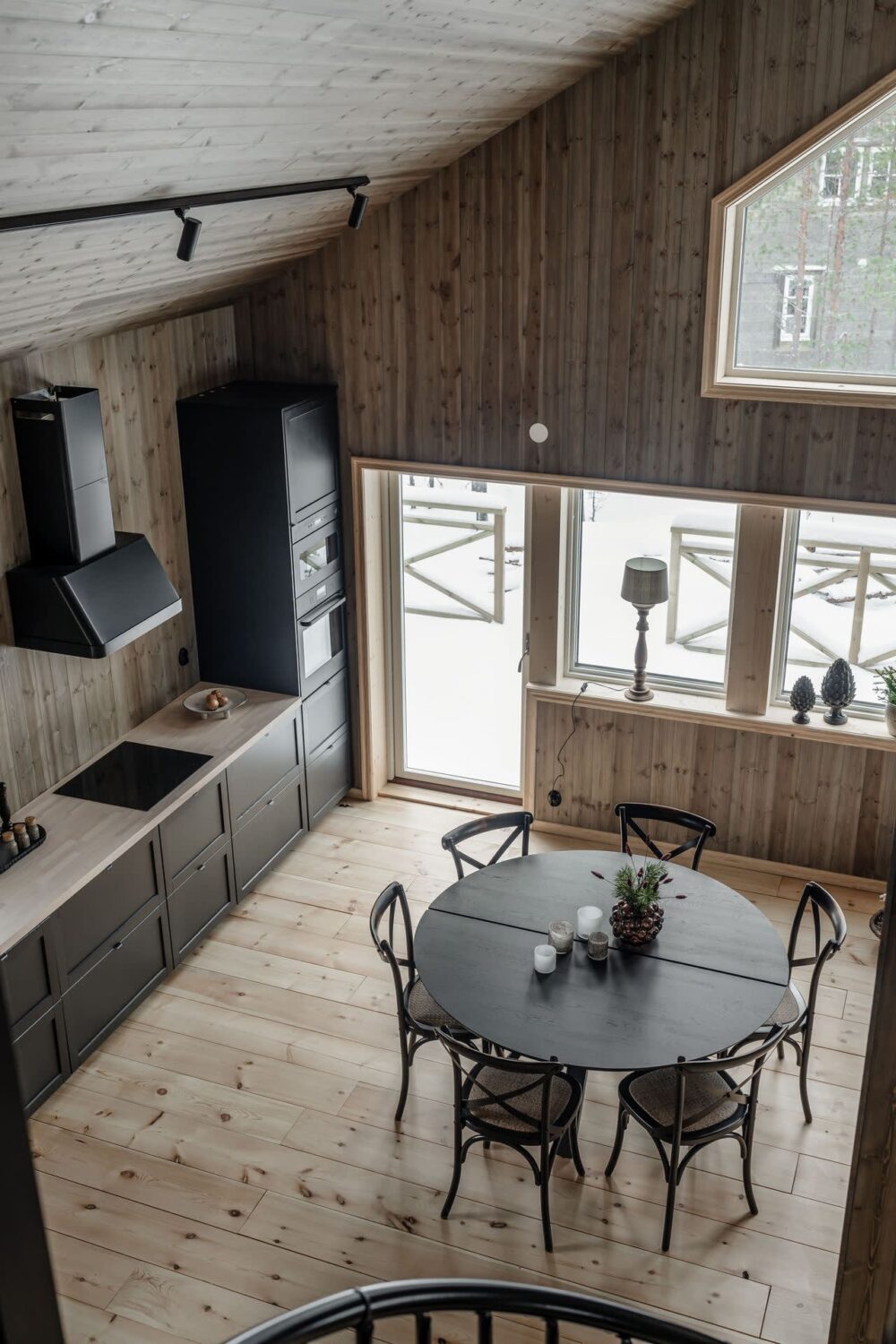A Cozy Log House in Sweden 10 kitchen-with-round-dining-table-pitched-ceiling