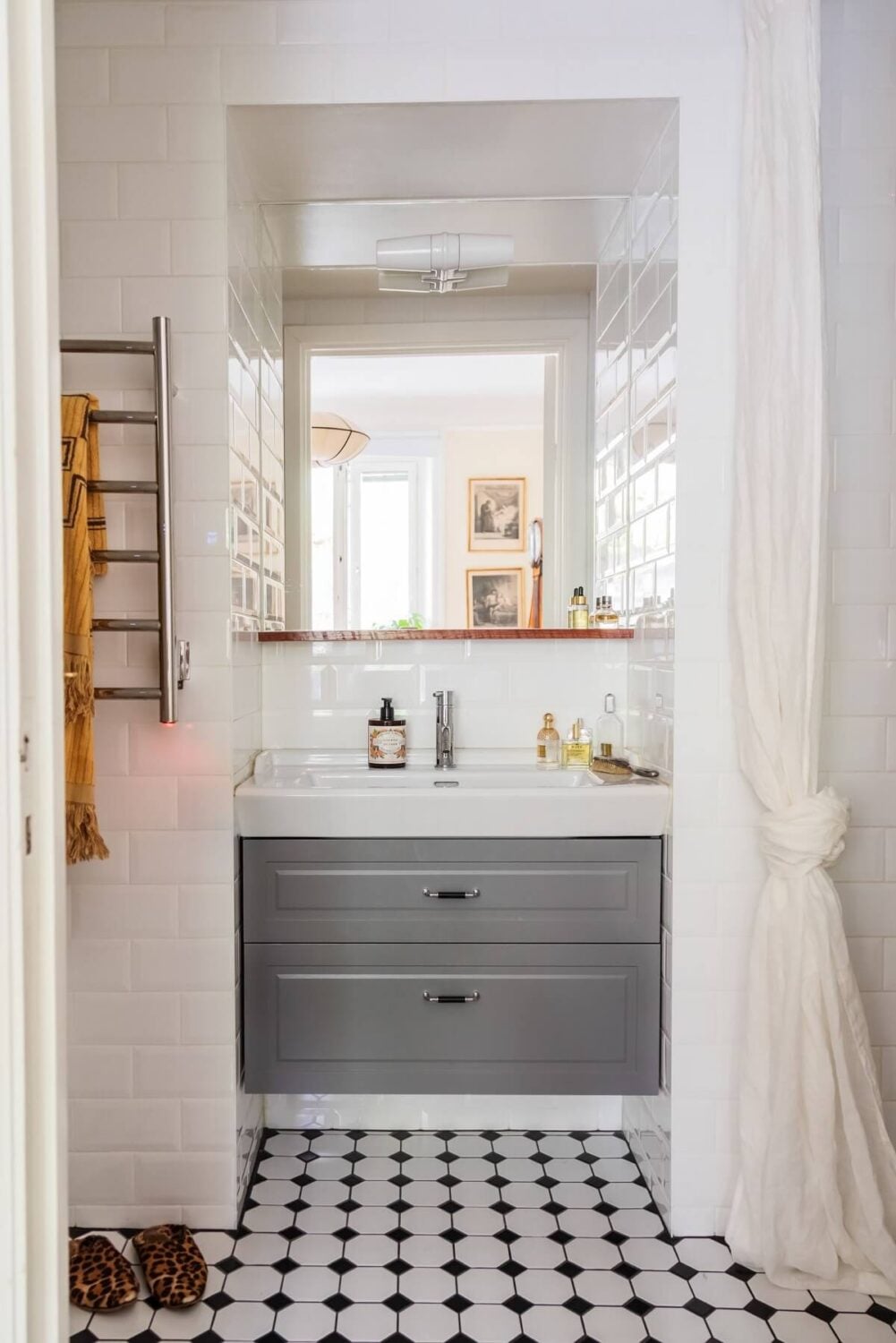 A Cozy Swedish Apartment with a Green Kitchen 28 light bedroom with whtie tiles and gray vanity