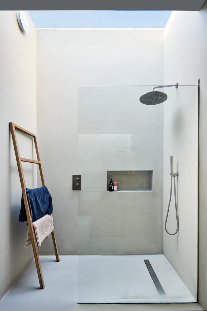 A Modern House Centered Around a Courtyard 20 minimalistic-bathroom-shower-with-skylight-nordroom