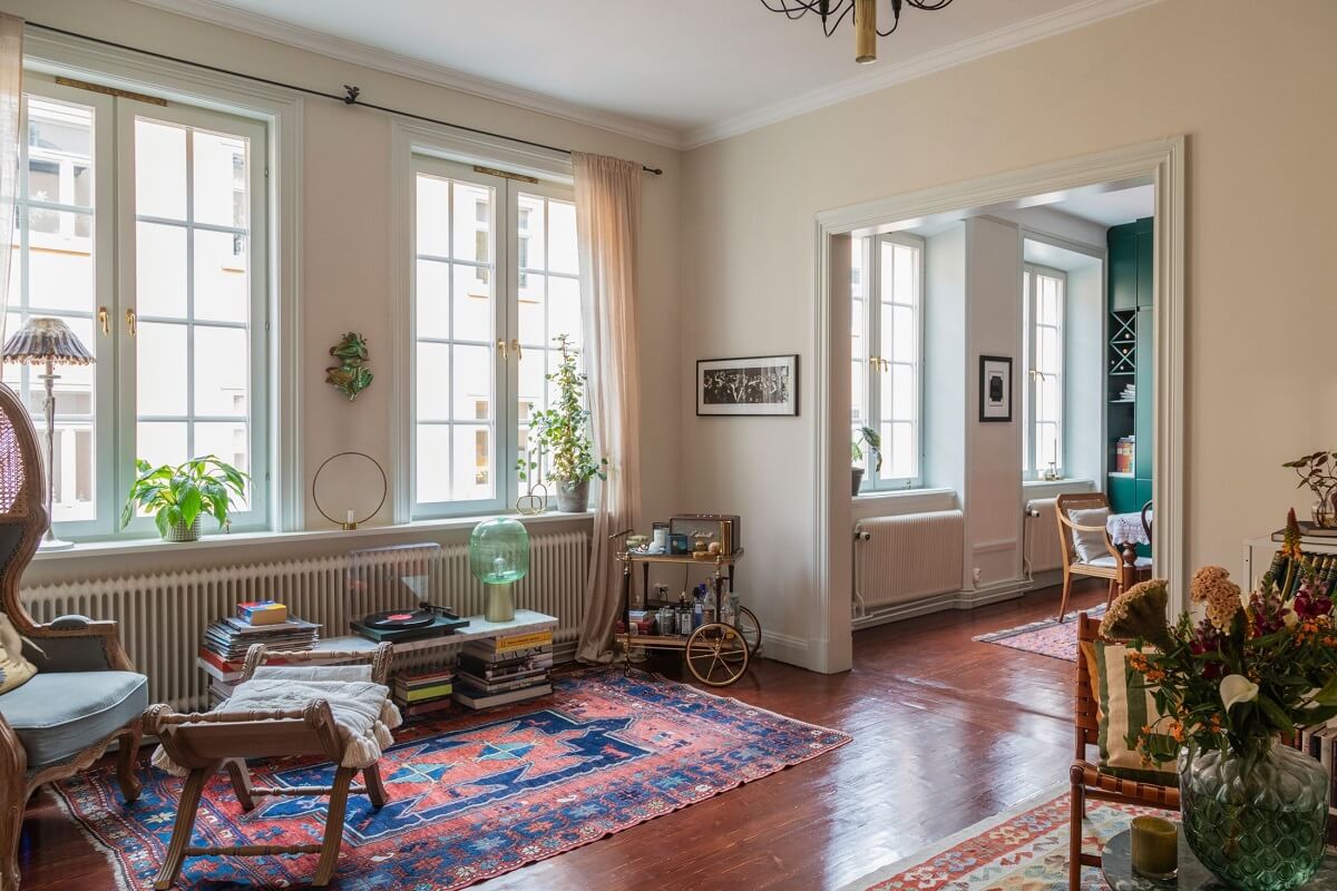 A Cozy Swedish Apartment with a Green Kitchen 3 open plan living room kitchen beige walls