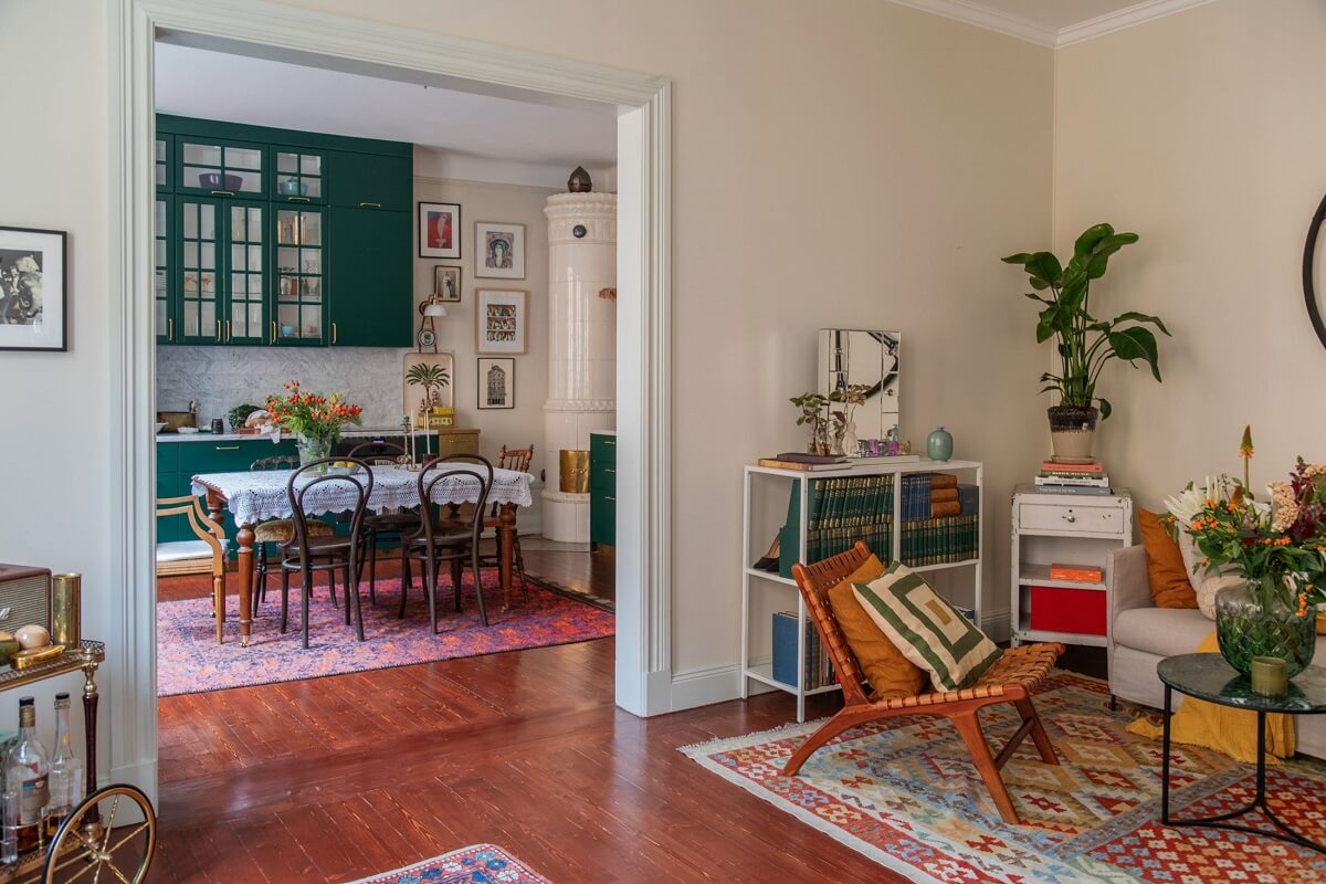 A Cozy Swedish Apartment with a Green Kitchen 5 open plan living room kitchen mahogany floor nordroom