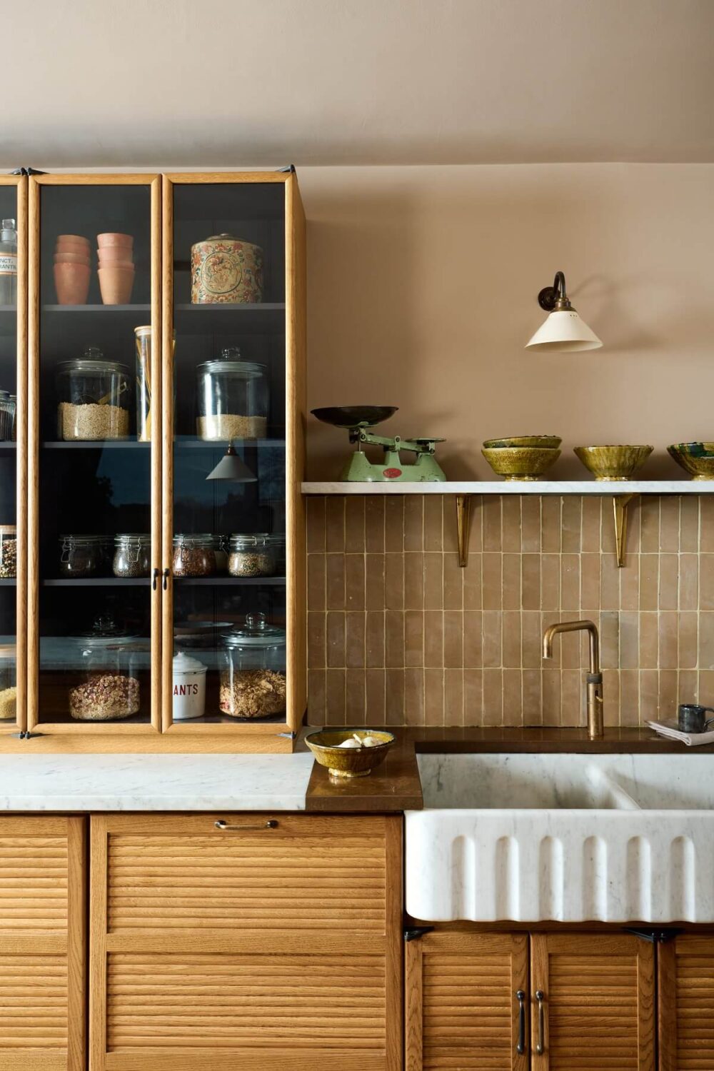 The Top Home Design Trends for 2026: Bold Color, Cozy Corners & Climate-Ready Living 30 sink-glass-cabinets-The-Haberdasher's-Kitchen-deVOL-nordroom