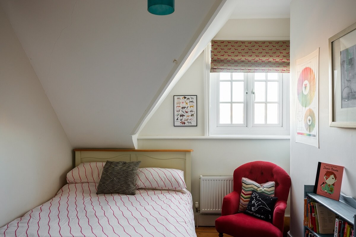 Playful Colors in a Historic Home in Kent 23 small-attic-bedroom-red-chair
