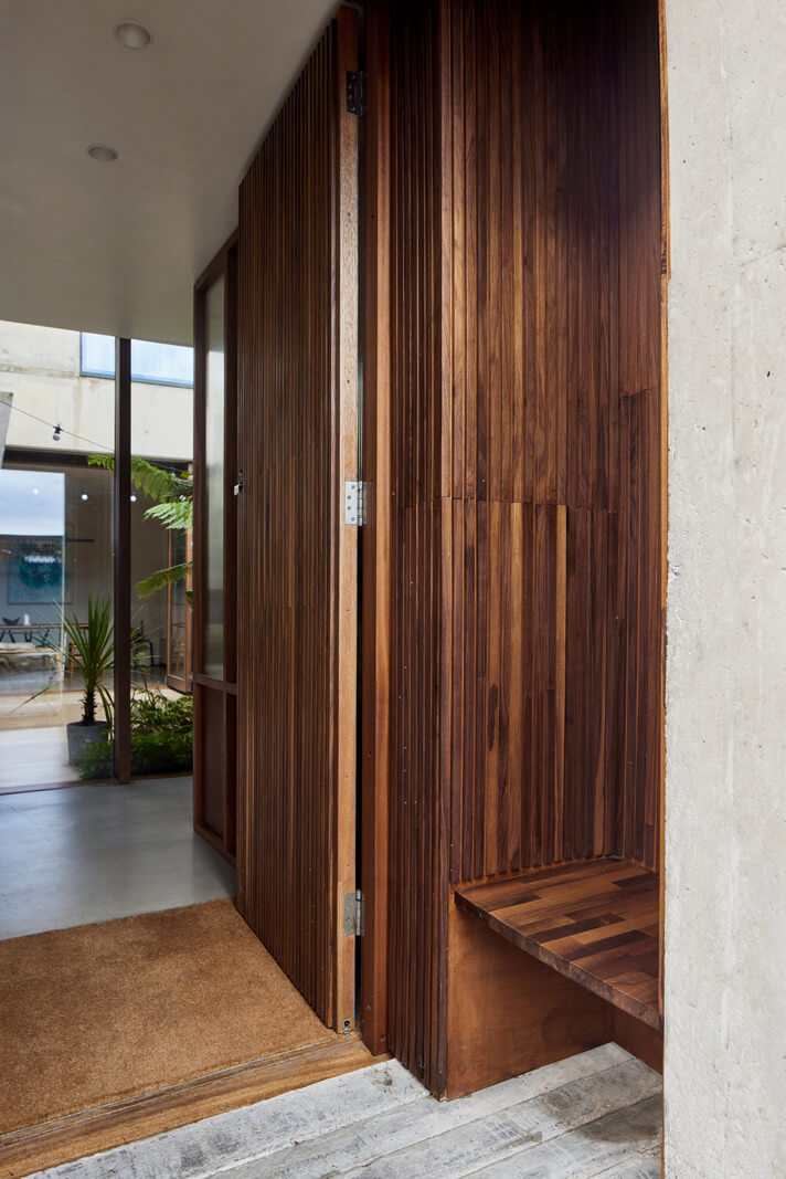 A Modern House Centered Around a Courtyard 17 wooden-entry-bench-nordroom