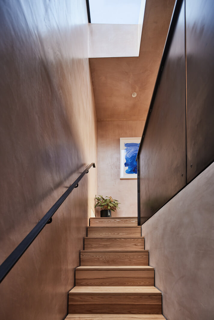 A Modern House Centered Around a Courtyard 13 wooden-staircase-skylight-nordroom