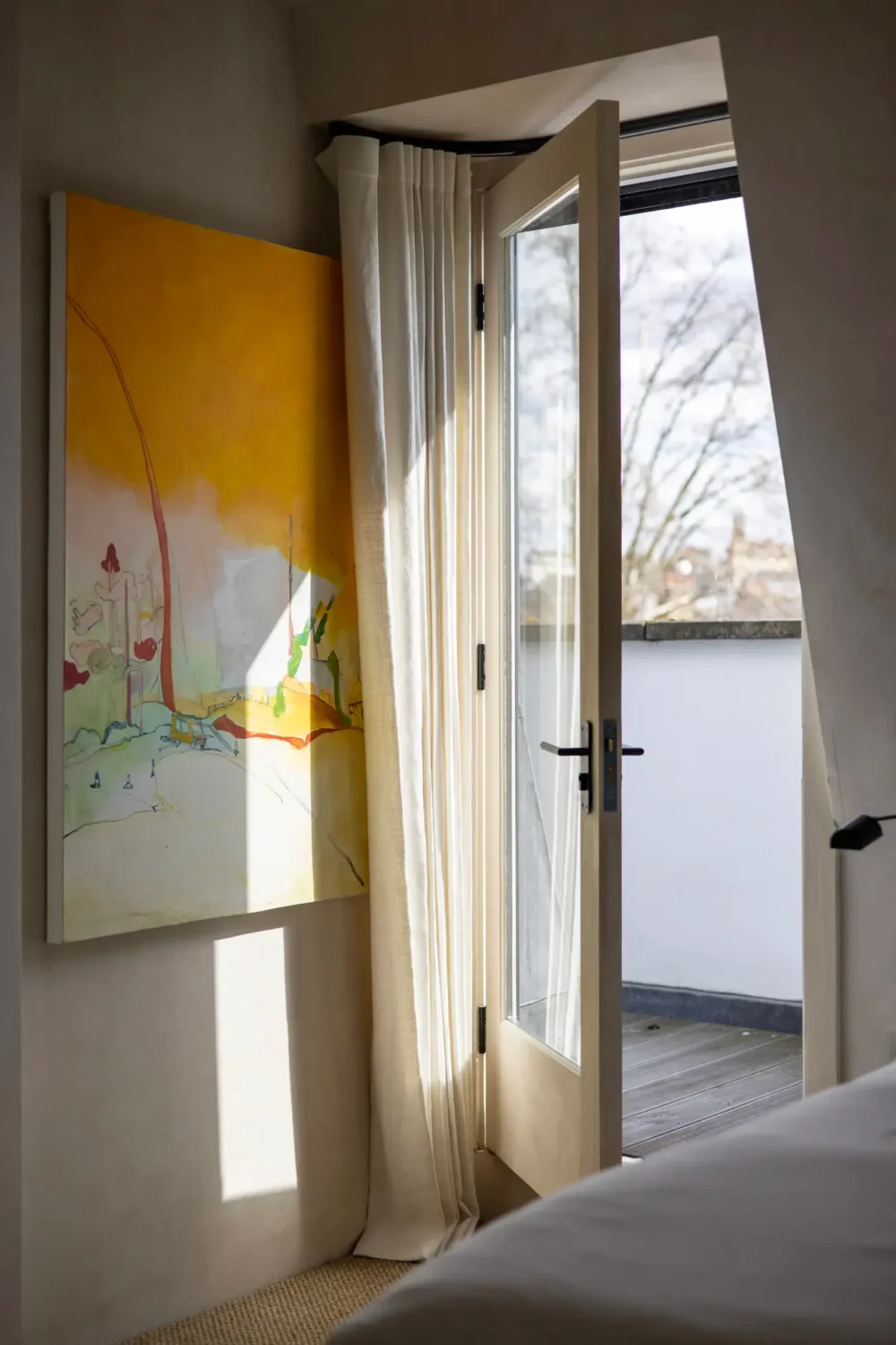 Modern Rustic Interiors in a Notting Hill Penthouse 16 yellow-artwork-bedroom