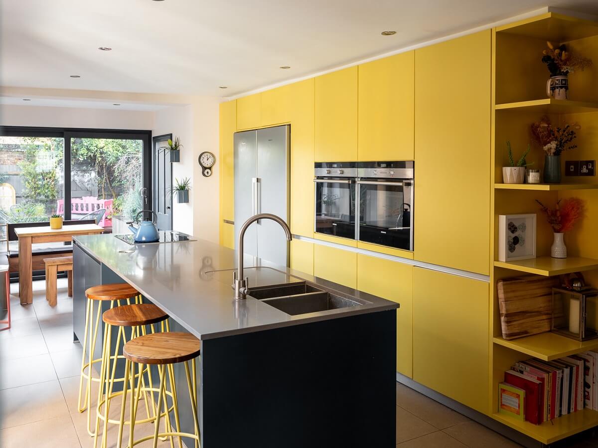 Playful Colors in a Historic Home in Kent 6 yellow-floor-to-ceiling-kitchen-cabinets-island-with-bar-stools-nordroom