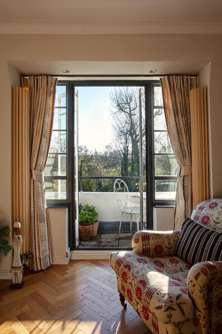 A Charming Apartment in an Art Deco Building in London 4 armchair-balcony-living-room