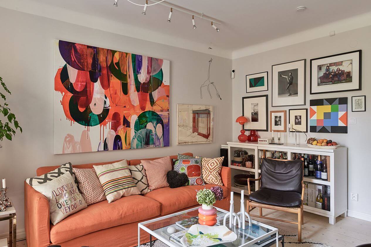 An Art-Filled Scandinavian Apartment 4 art-filled-living-room-orange-pink-sofa-nordroom