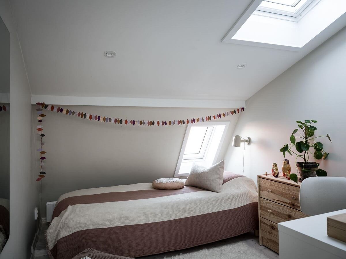 A Light-Filled Swedish Duplex is a Lovely Family Home 26 attic bedroom with skylight nordroom