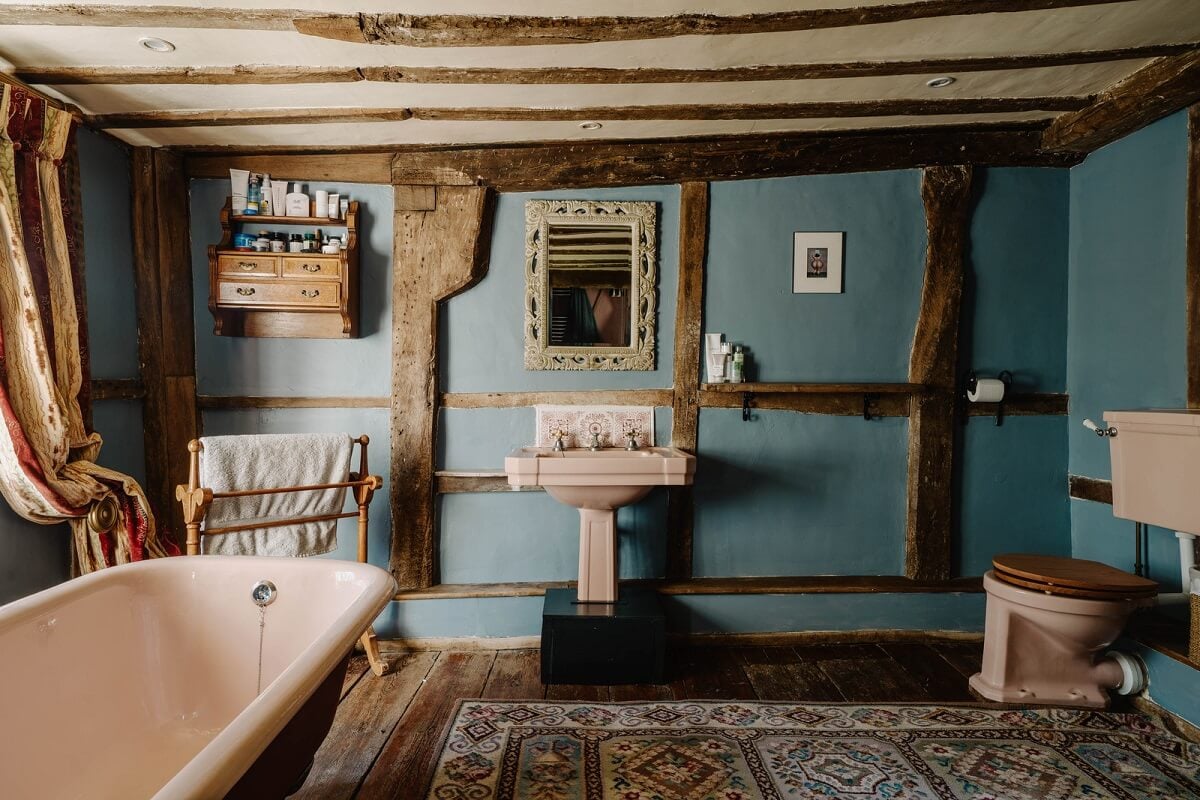 A Cozy Historic English Country House with Exposed Beams 19 bathroom exposed beams blue walls english country house nordroom