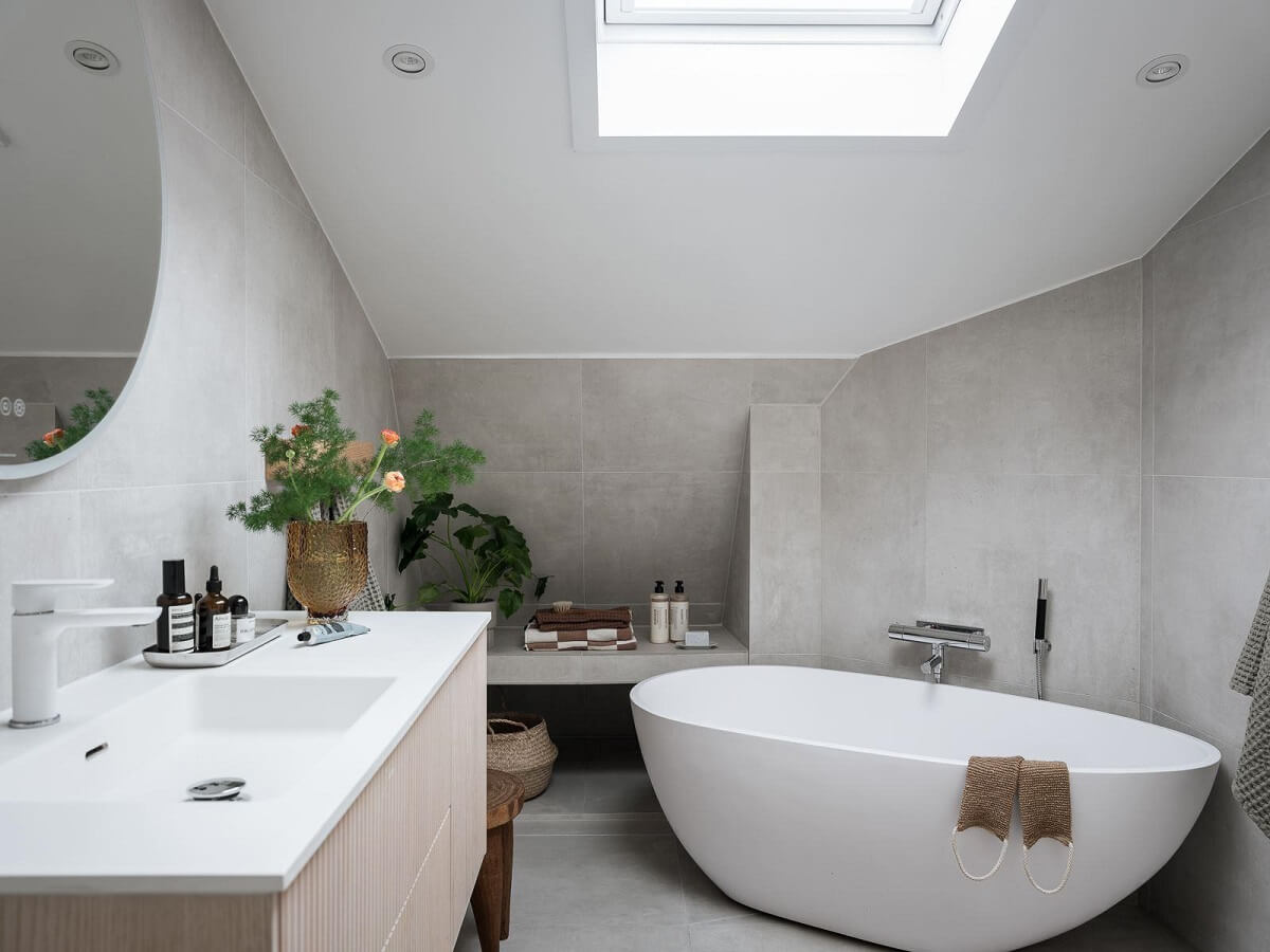 A Light-Filled Swedish Duplex is a Lovely Family Home 29 bathroom slanted ceiling skylight freestanding bath nordroom