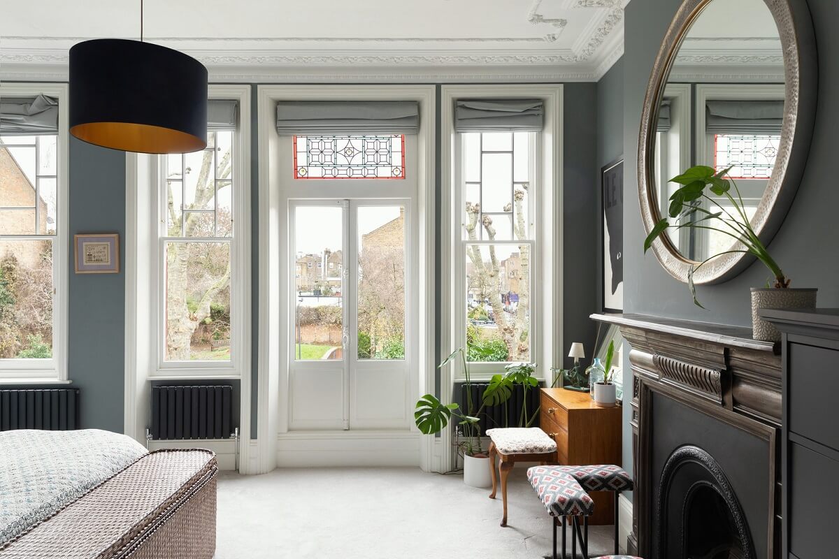 A Victorian House in London with Three Outdoor Spaces 18 bedroom gray walls fireplace round mirror