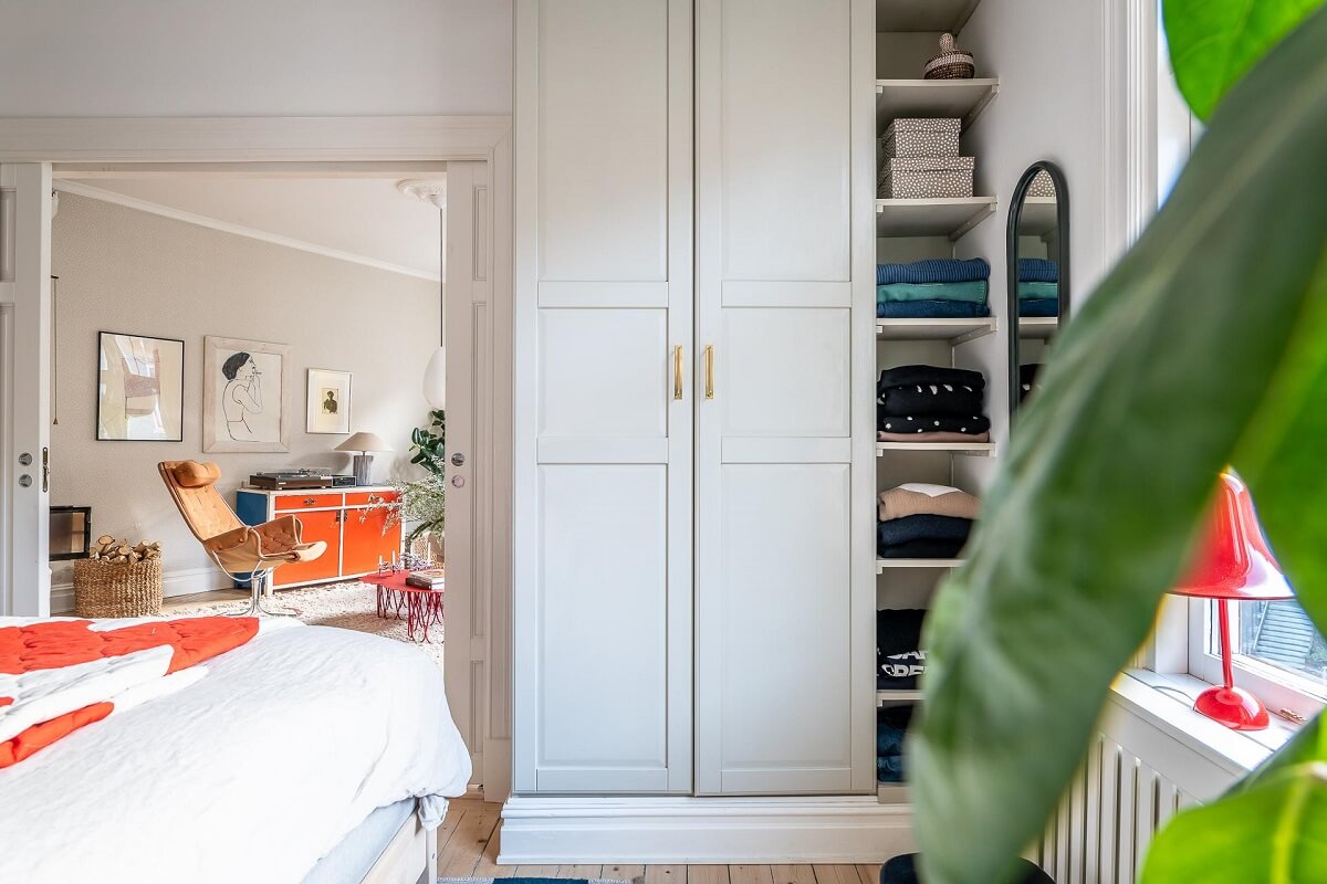 Primary Color Accents in a Light Swedish Apartment 14 bedroom-open-and-closed-wardrobes