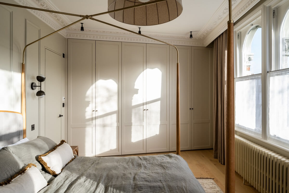 A Renovated Victorian House with Oak Features 13 bedroom with canopy bed and built in wardrobes