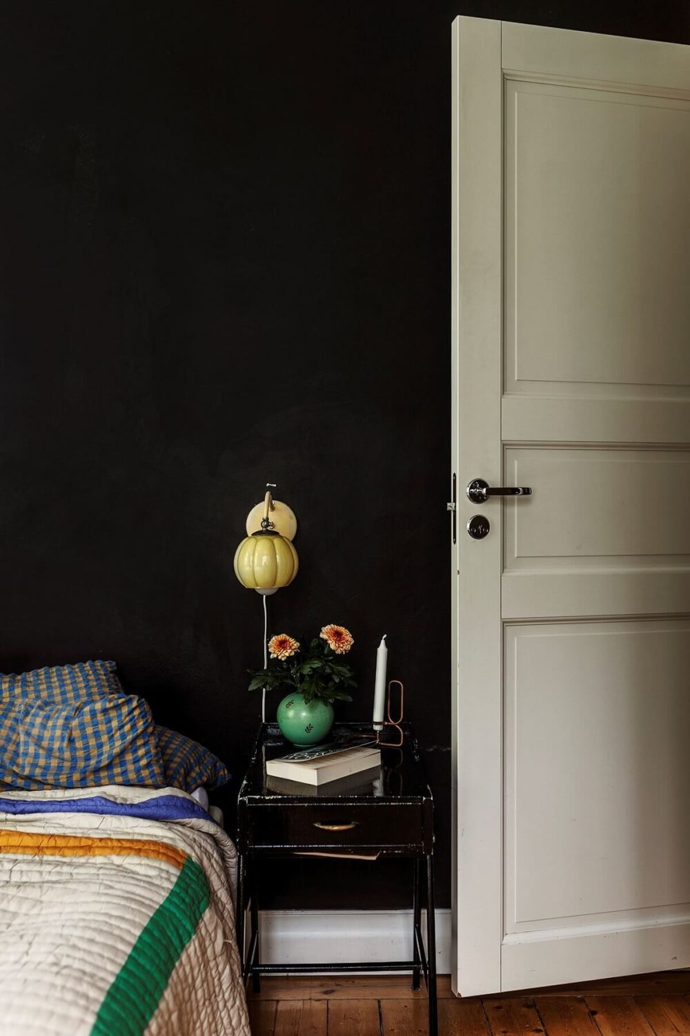 A Swedish Apartment with a Yellow Living Room 10 black walls bedroom wooden floorboards nordroom