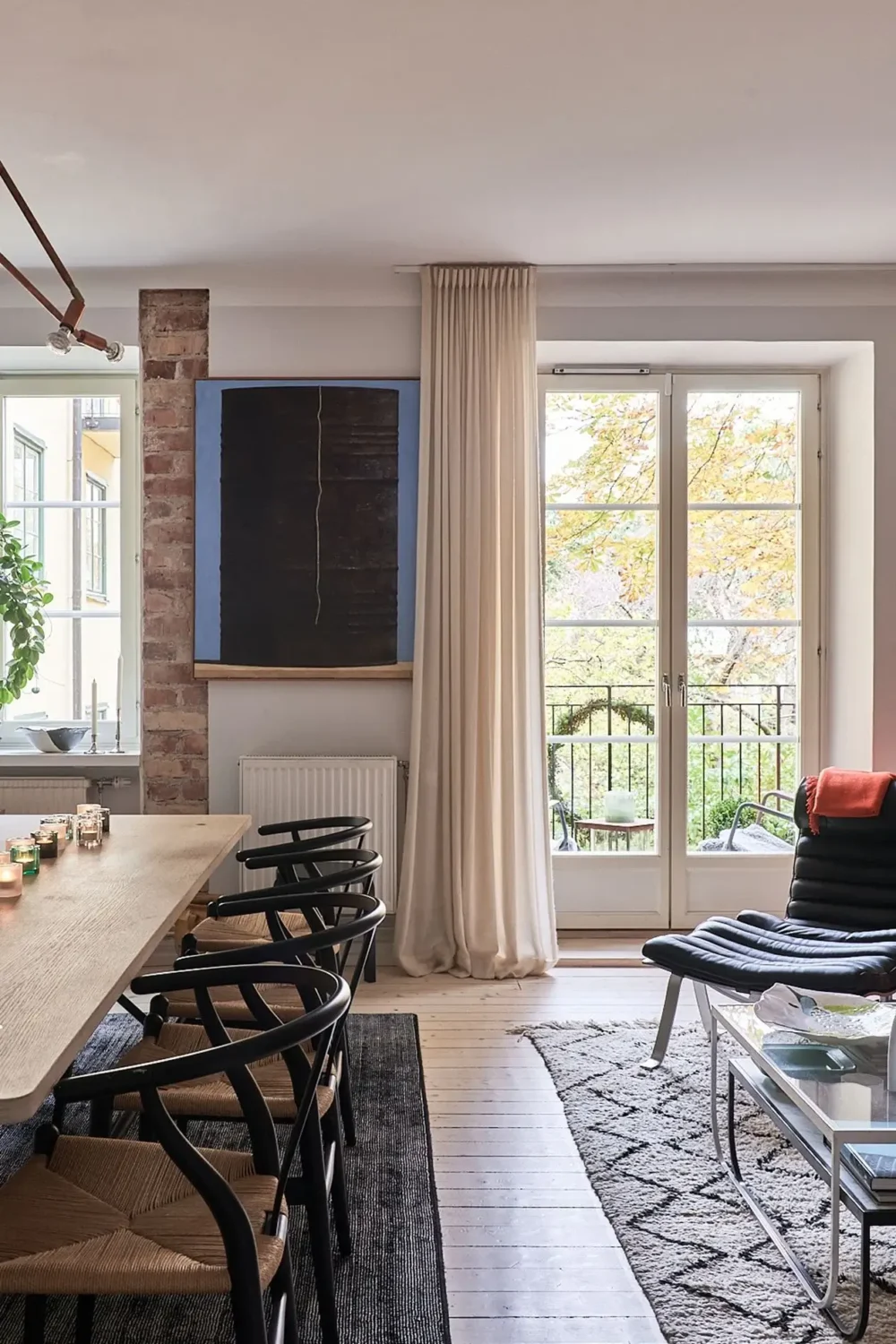 An Art-Filled Scandinavian Apartment 7 black-wishbone-chairs-dining-table-nordroom