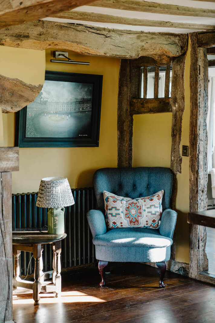 A Cozy Historic English Country House with Exposed Beams 5 blue chair historic room english country house nordroom