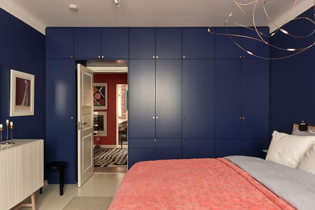 An Art-Filled Scandinavian Apartment 17 bold-bedroom-built-in-wardrobes-blue-walls-nordroom