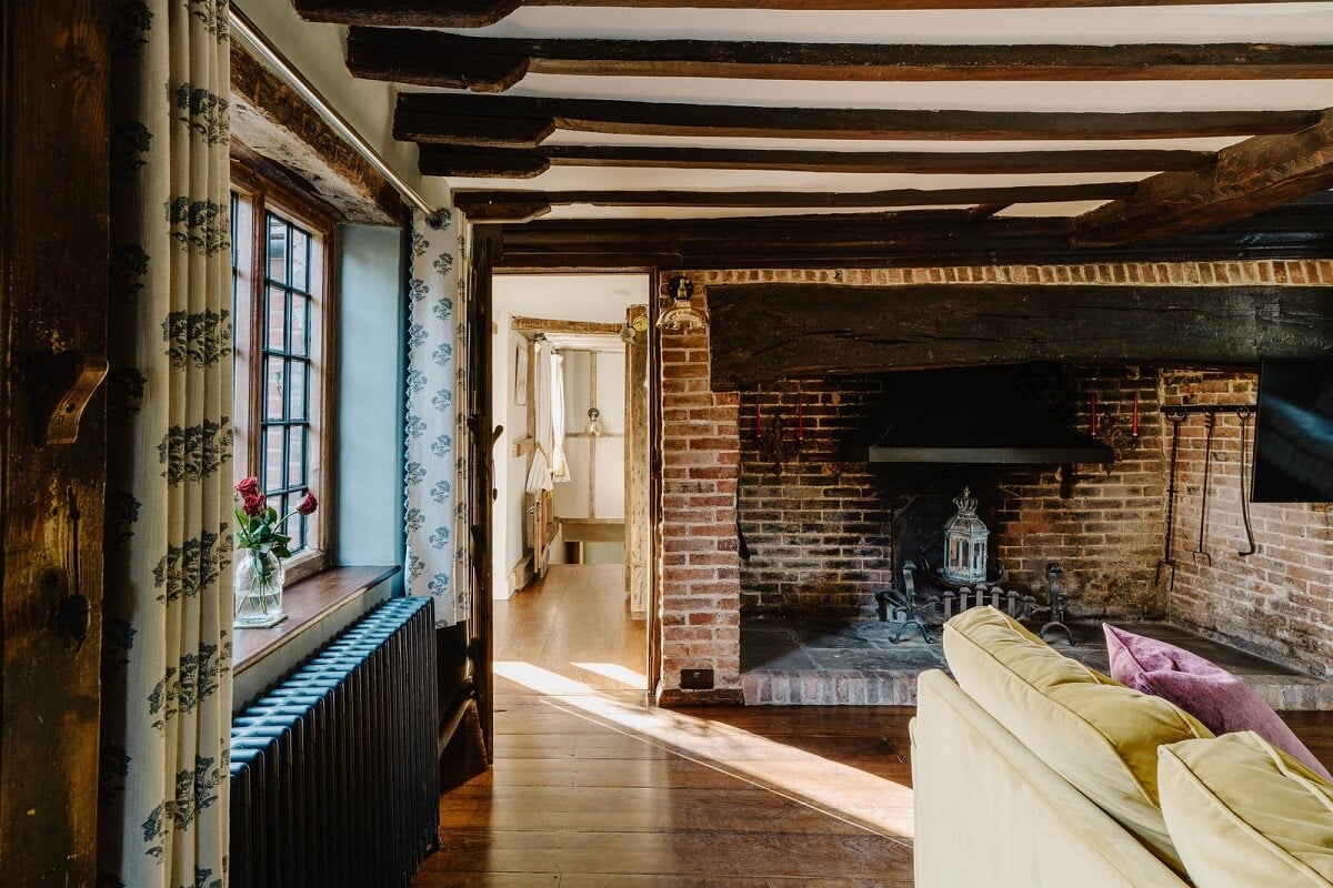 A Cozy Historic English Country House with Exposed Beams 8 brick fireplace living room exposed wooden beams nordroom