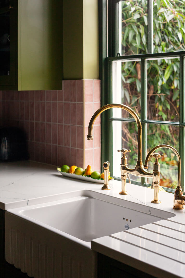 Bold Colors in a Charming Historic House in England 13 butler-sink-brass-fittings-green-pink-kitchen-nordroom