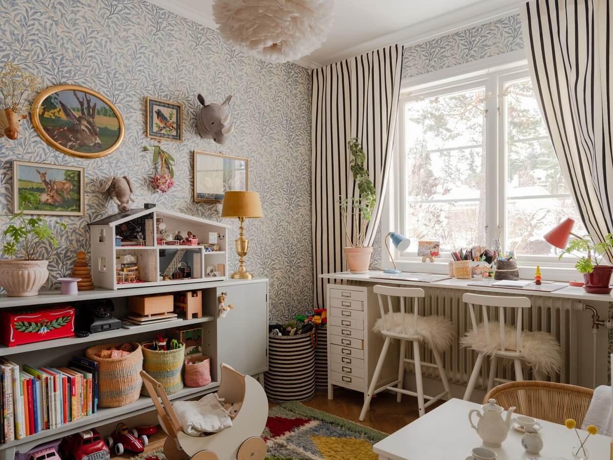 A Light Family Home in a Historic Yellow Villa 9 children play room with desk in front of windows striped curtains nordroom