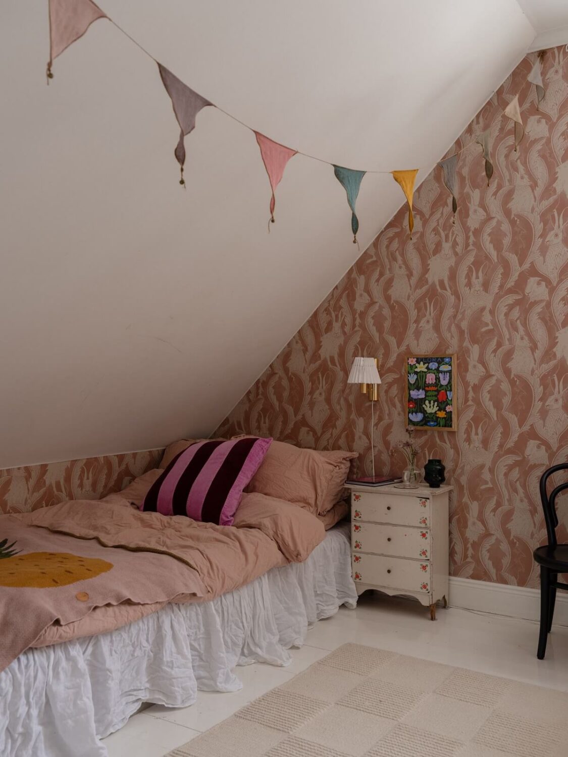 A Light Family Home in a Historic Yellow Villa 24 children room pink wallpaper slanted ceiling nordroom