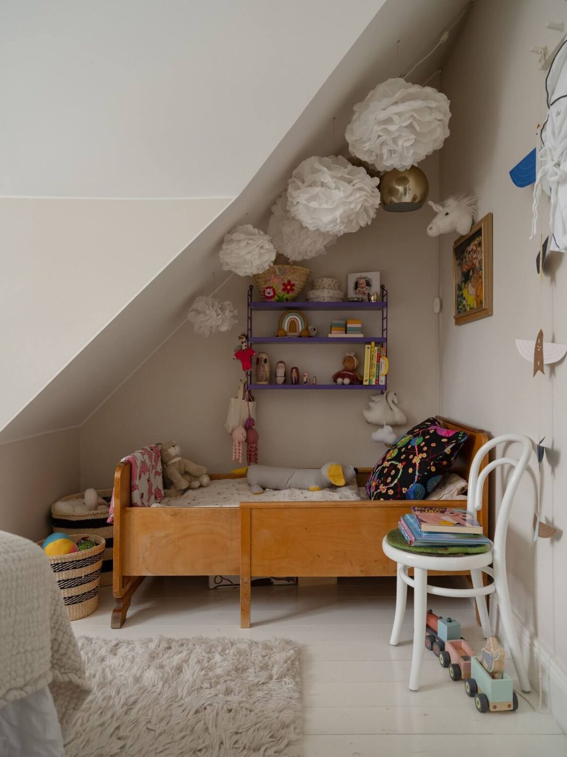 A Light Family Home in a Historic Yellow Villa 28 children room slanted ceiling wall shelves nordroom