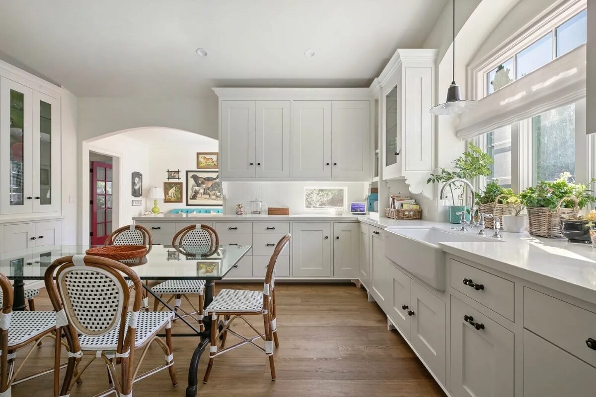Emma Stone's Colorful Spanish-Style Los Angeles Home is For Sale 6 classic-white-kitchen-glass-dining-table-emma-stone-nordroom