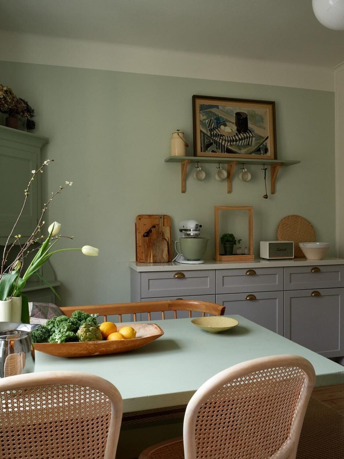 A Charming Swedish Apartment with a Cottage-Style Kitchen 15 cottage style kitchen gray cabinets green walls nordroom