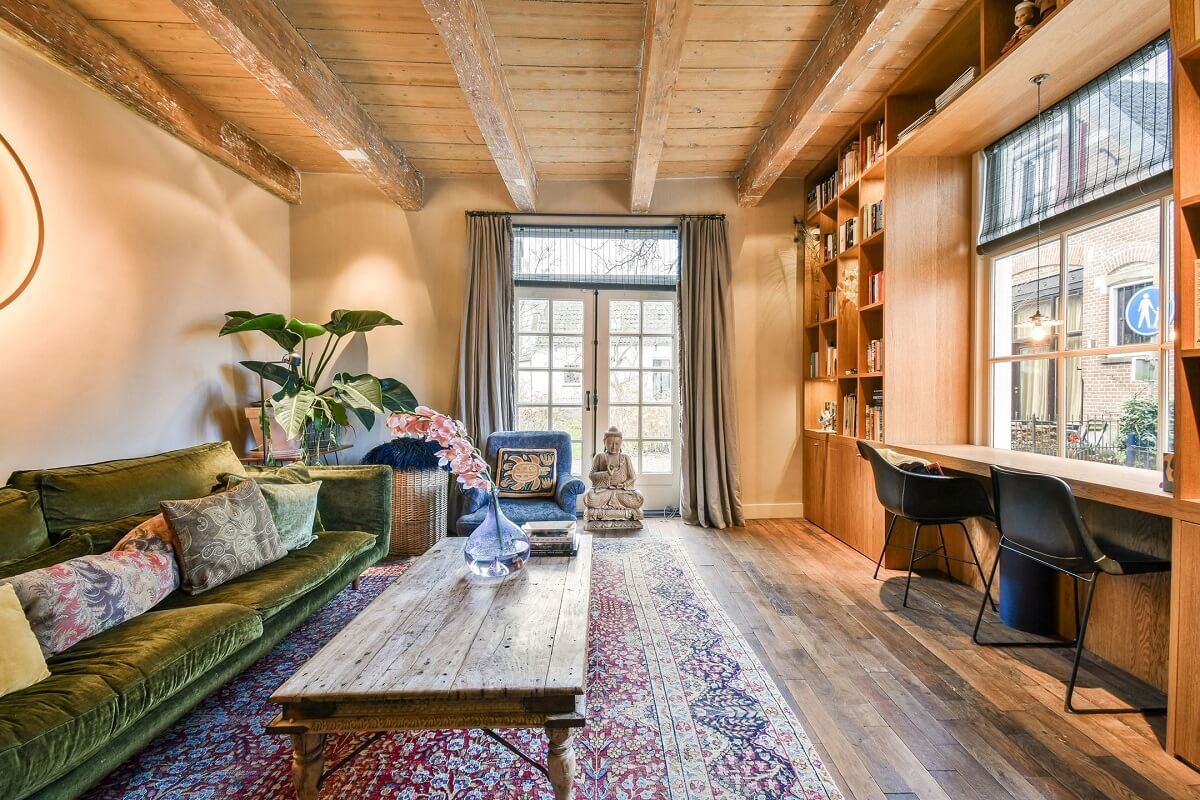 Wooden Interiors in a Historic Dutch Family Home 2 cozy-wooden-living-room-green-sofa-desk-under-window-nordroom