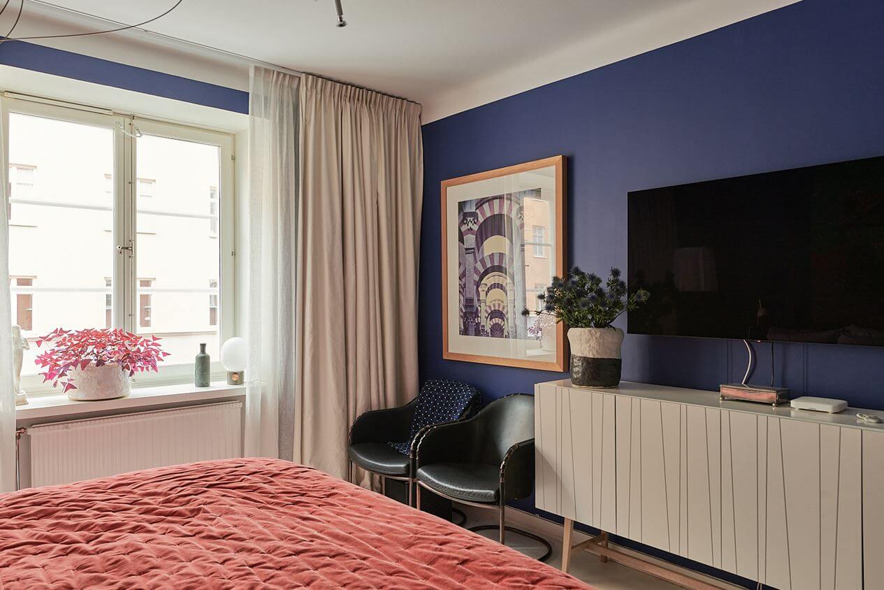 An Art-Filled Scandinavian Apartment 16 dark-violet-blue-walls-bedroom