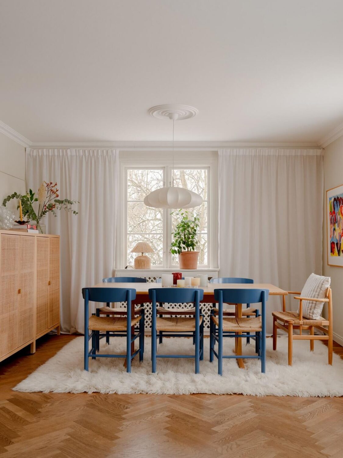 A Light Family Home in a Historic Yellow Villa 4 dining area with large rug and blue dining chairs nordroom