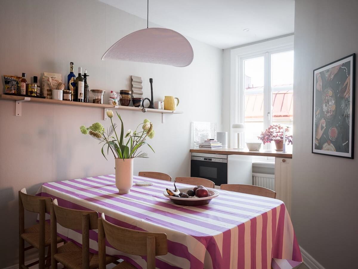 A Light-Filled Swedish Duplex is a Lovely Family Home 11 dining table with pink striped tablecloth nordroom