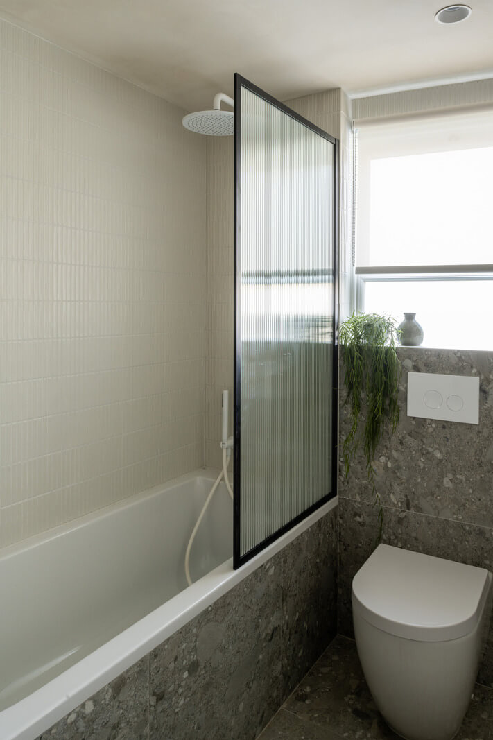 A Renovated Victorian House with Oak Features 23 gray bathroom with bath nordroom