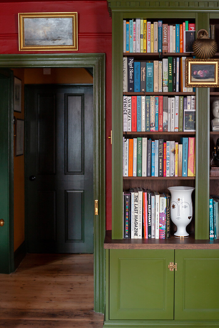 Bold Colors in a Charming Historic House in England 7 green-bookcases-in-red-room-nordroom