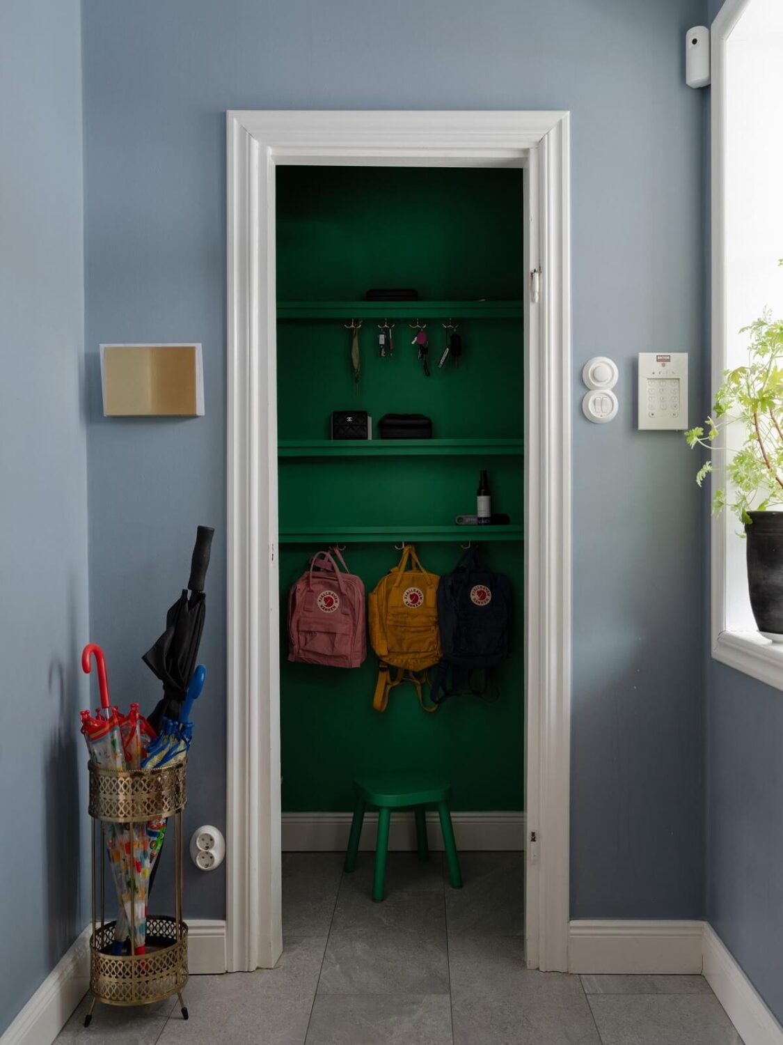 A Light Family Home in a Historic Yellow Villa 19 green painted hallway storage nordroom