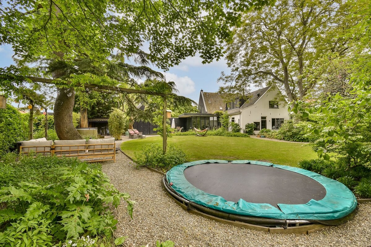 Wooden Interiors in a Historic Dutch Family Home 31 gren-garden-with-trampoline-nordroom