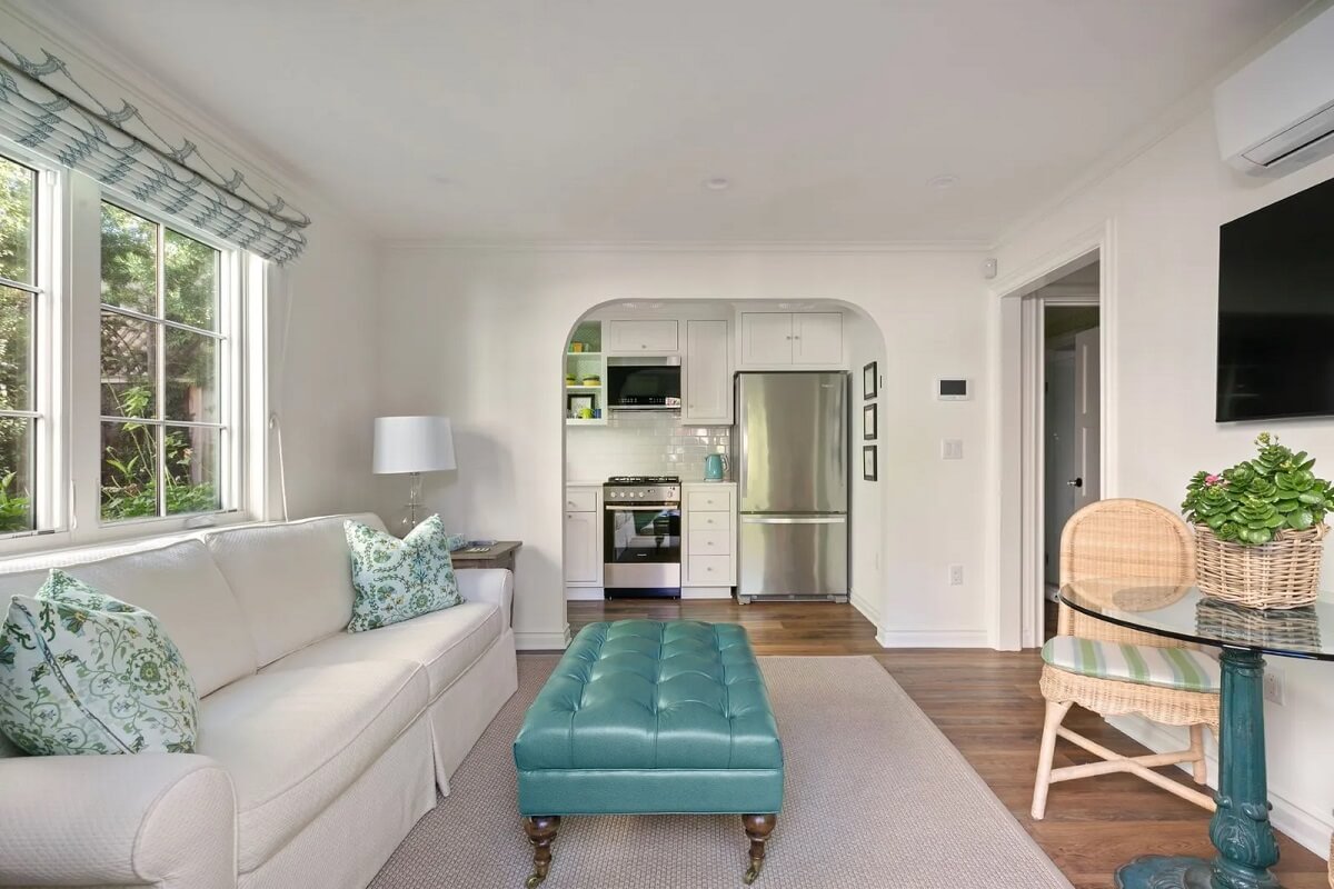 Emma Stone's Colorful Spanish-Style Los Angeles Home is For Sale 25 guest-house-living-room-blue-ottoman-emma-stone-nordroom