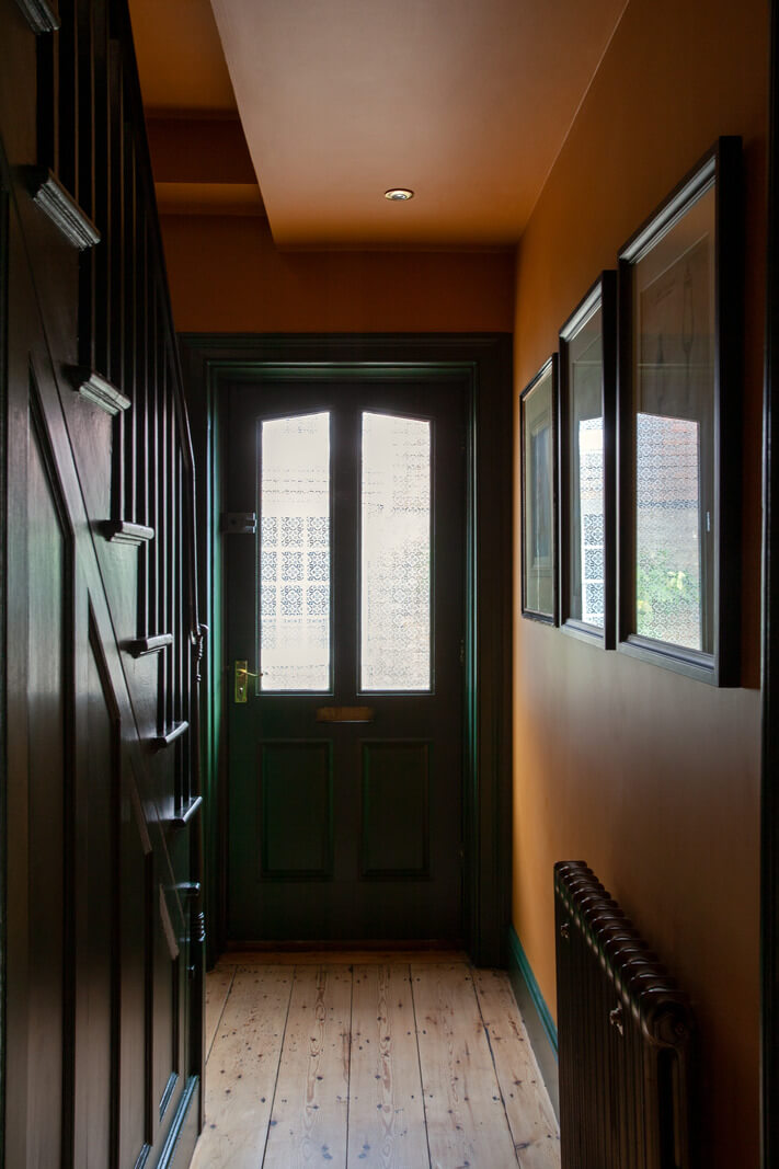 Bold Colors in a Charming Historic House in England 17 hallway-orange-brown-walls-green-front-door-nordroom