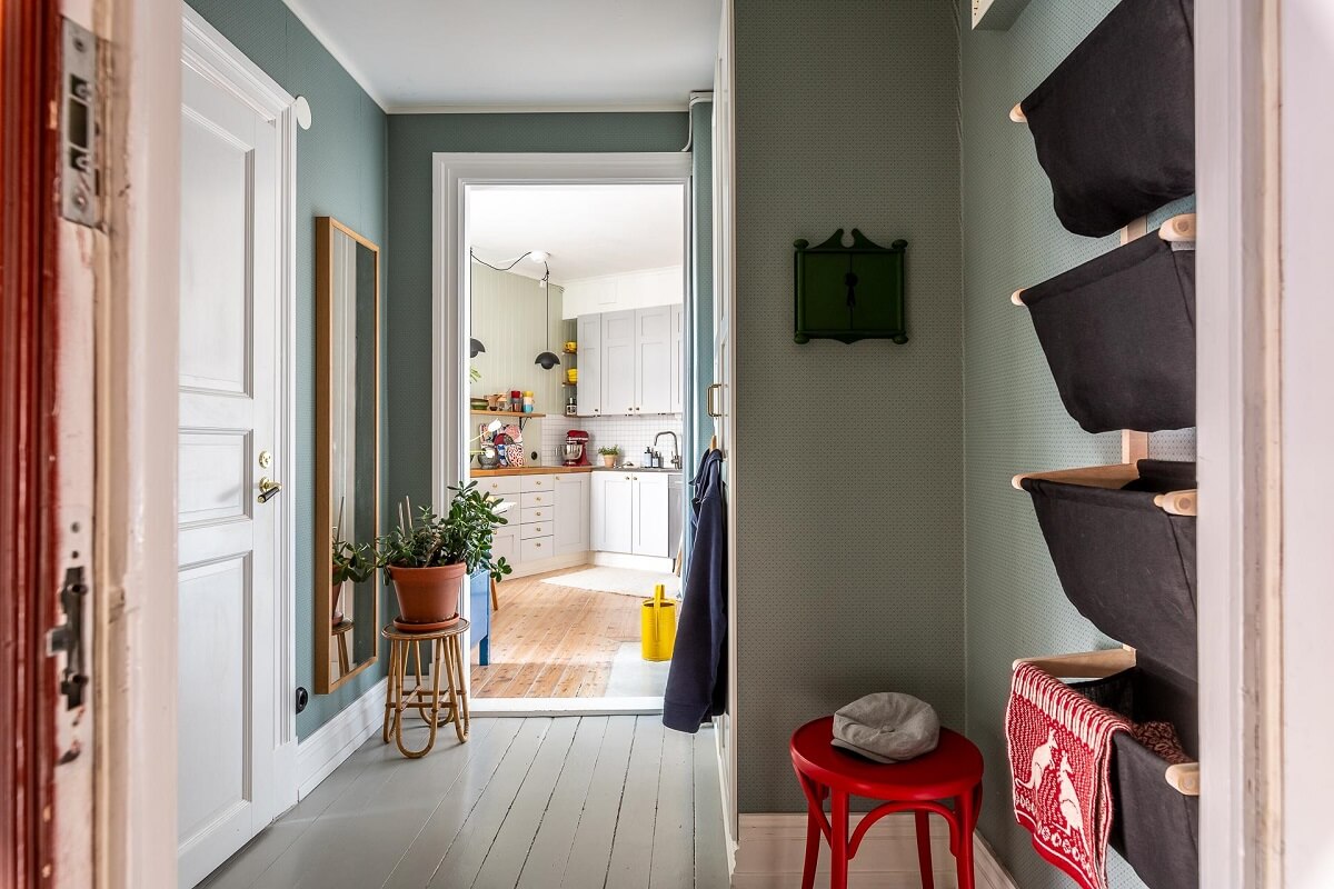Primary Color Accents in a Light Swedish Apartment 20 hallway-wall-storage-nordroom