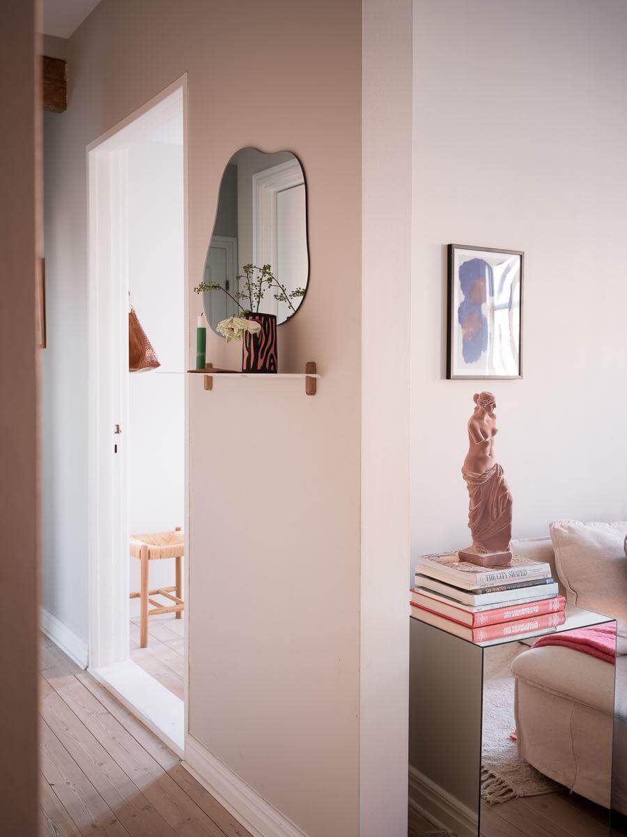 A Light-Filled Swedish Duplex is a Lovely Family Home 12 hallway with mirror and small shelf