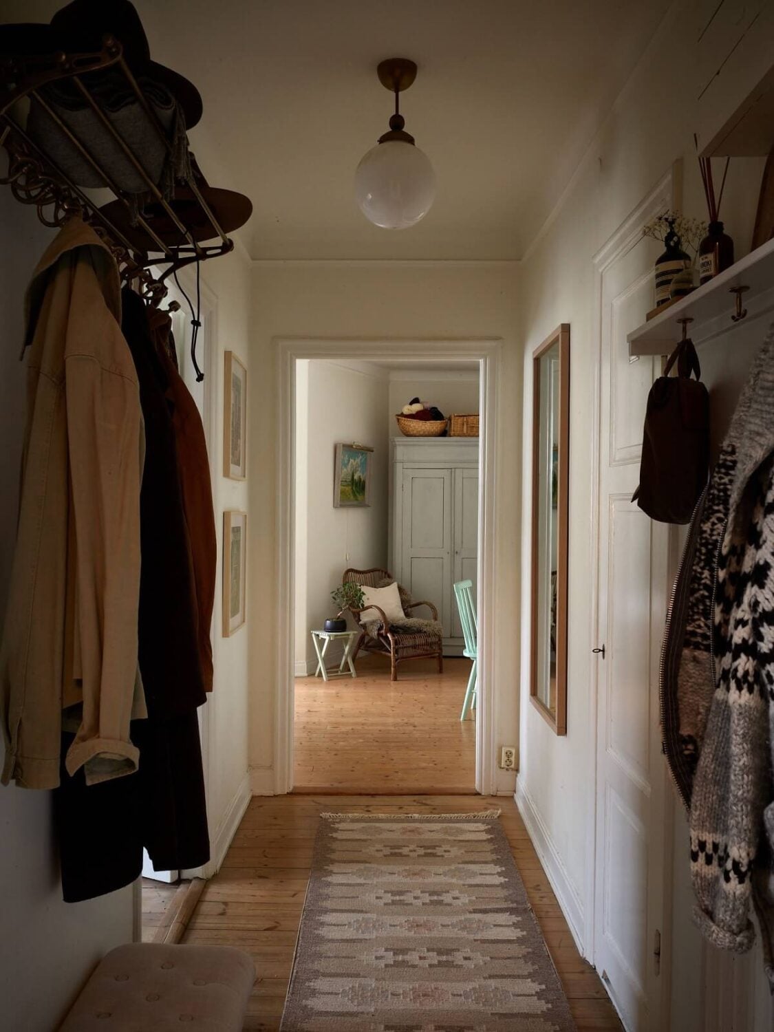 A Charming Swedish Apartment with a Cottage-Style Kitchen 18 hallway with wooden floor and runner