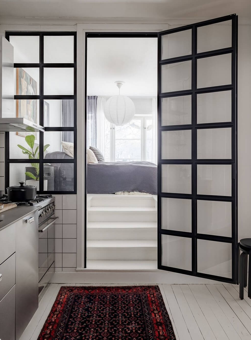 A Light Apartment with a Stainless Steel Kitchen 16 industrial steel glass doors to bedroom