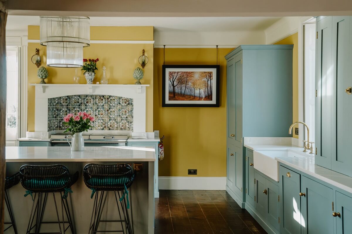 A Cozy Historic English Country House with Exposed Beams 3 kitchen blue cabinets yellow walls nordroom