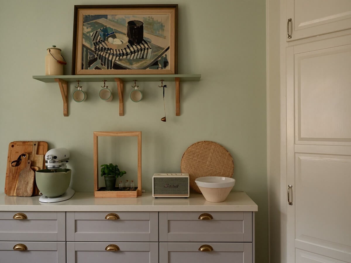 A Charming Swedish Apartment with a Cottage-Style Kitchen 17 kitchen detail gray cabinets pale green walls nordroom