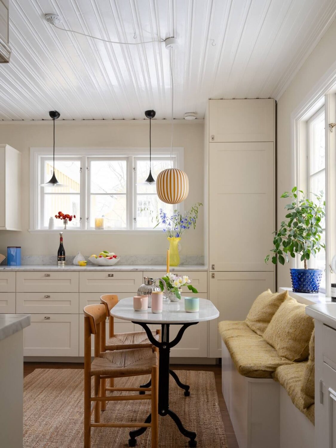 A Light Family Home in a Historic Yellow Villa 12 kitchen dining area with seating bench nordroom