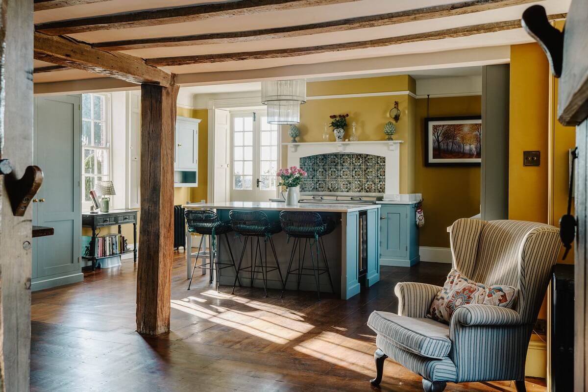 A Cozy Historic English Country House with Exposed Beams 1 kitchen exposed wooden beams yellow walls nordroom